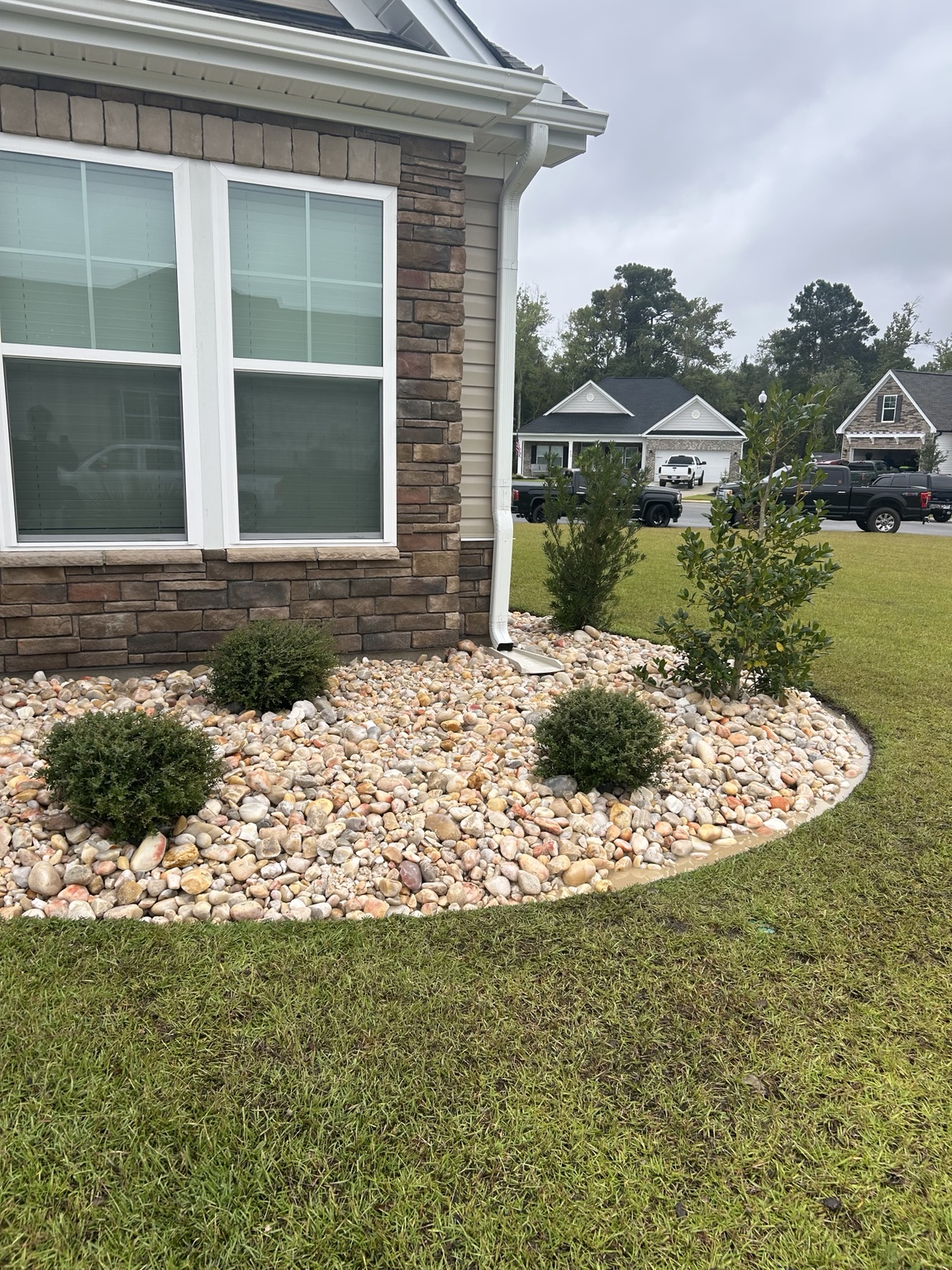 Completed front foundation bed with shrubs and 2 to 5 inch Carolina River Rock